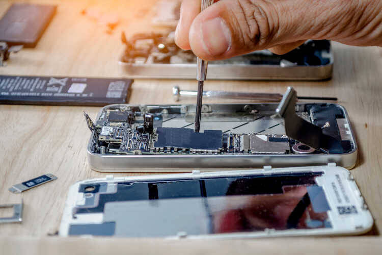 Close-up of a smartphone being repaired, with internal components exposed - mobile phone repair process.